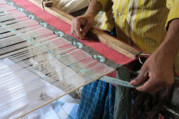 Craftswoman weaving a Glaoui rug for Gan in India. Photo courtesy of Gan.