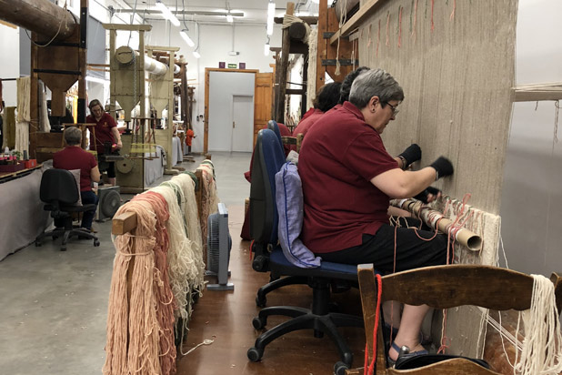 Craftwomen weaving rugs
